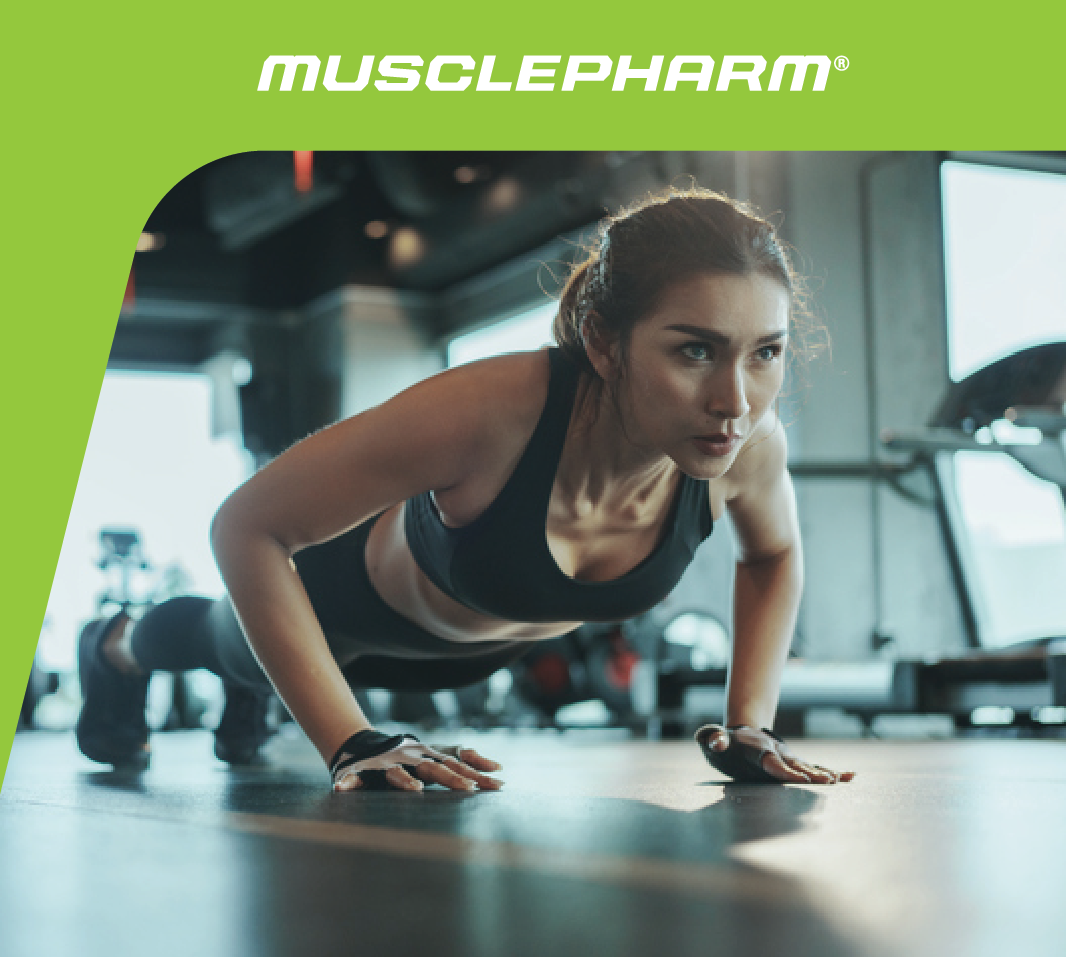 MusclePharm Weekly Workout 08 graphic featuring a woman performing push-ups on the floor in a gym environment.