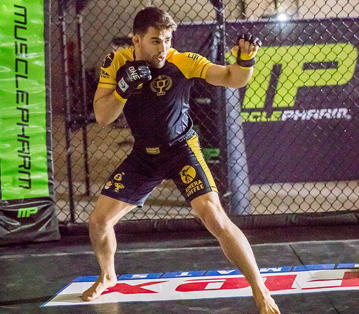 MMA fighter Garry Tonon in fight gear inside an octagon cage.