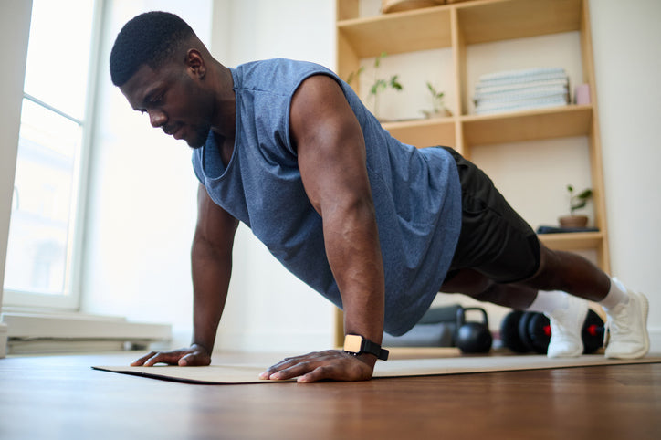 MusclePharm graphic titled 'Stars, Stripes & Sweat Sesh' featuring a man holding a plank position on a yoga mat indoors.